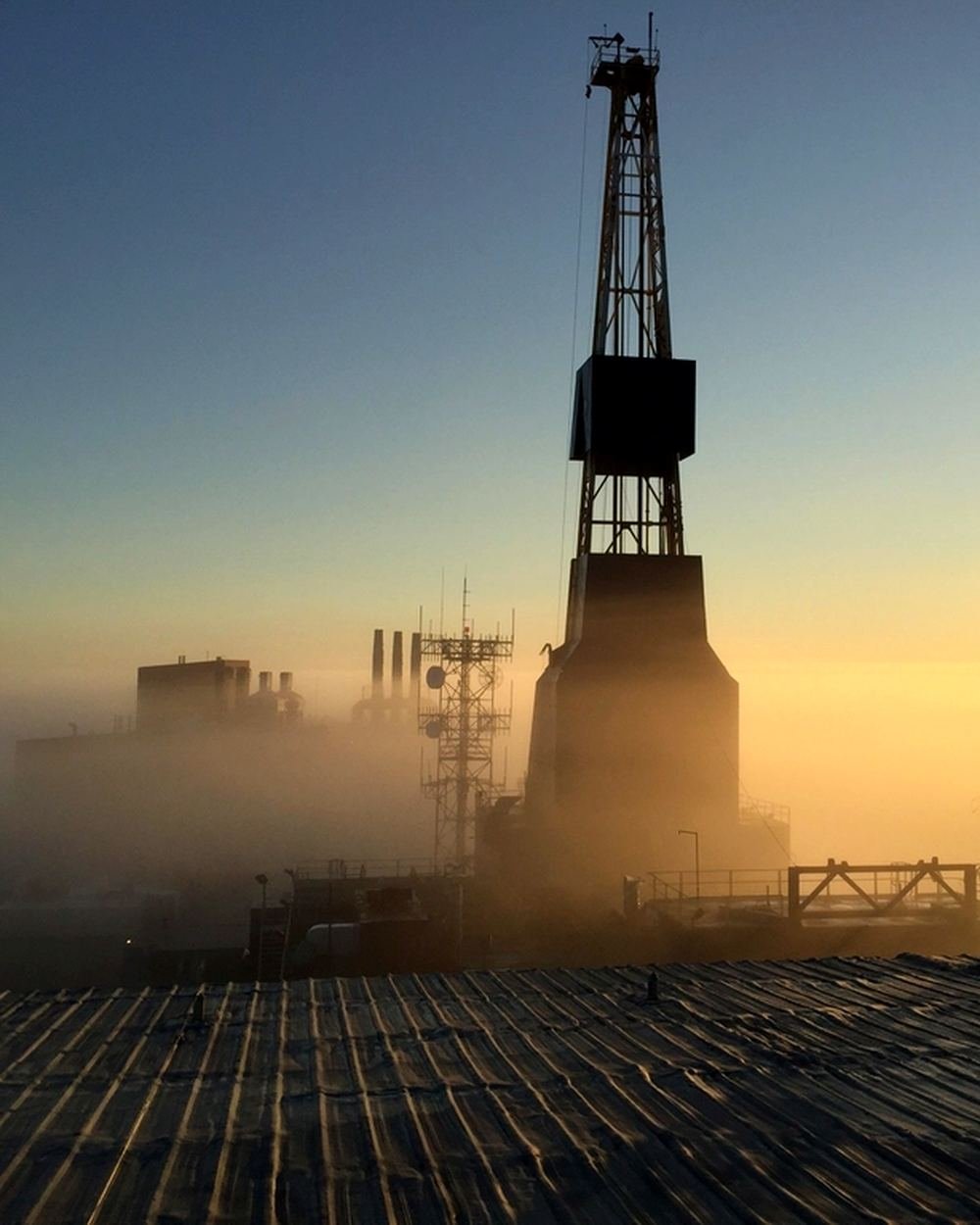 Century Solutions land drilling rig on location at dusk